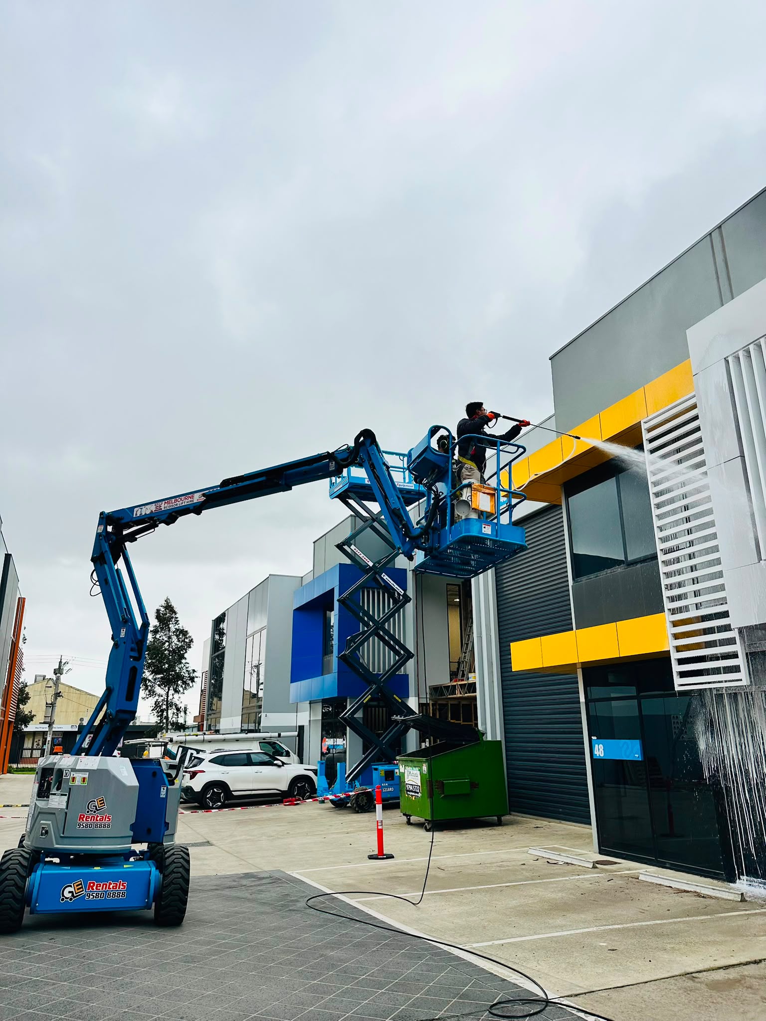 Pristine Sheen exterior cleaner working from an elevated platform