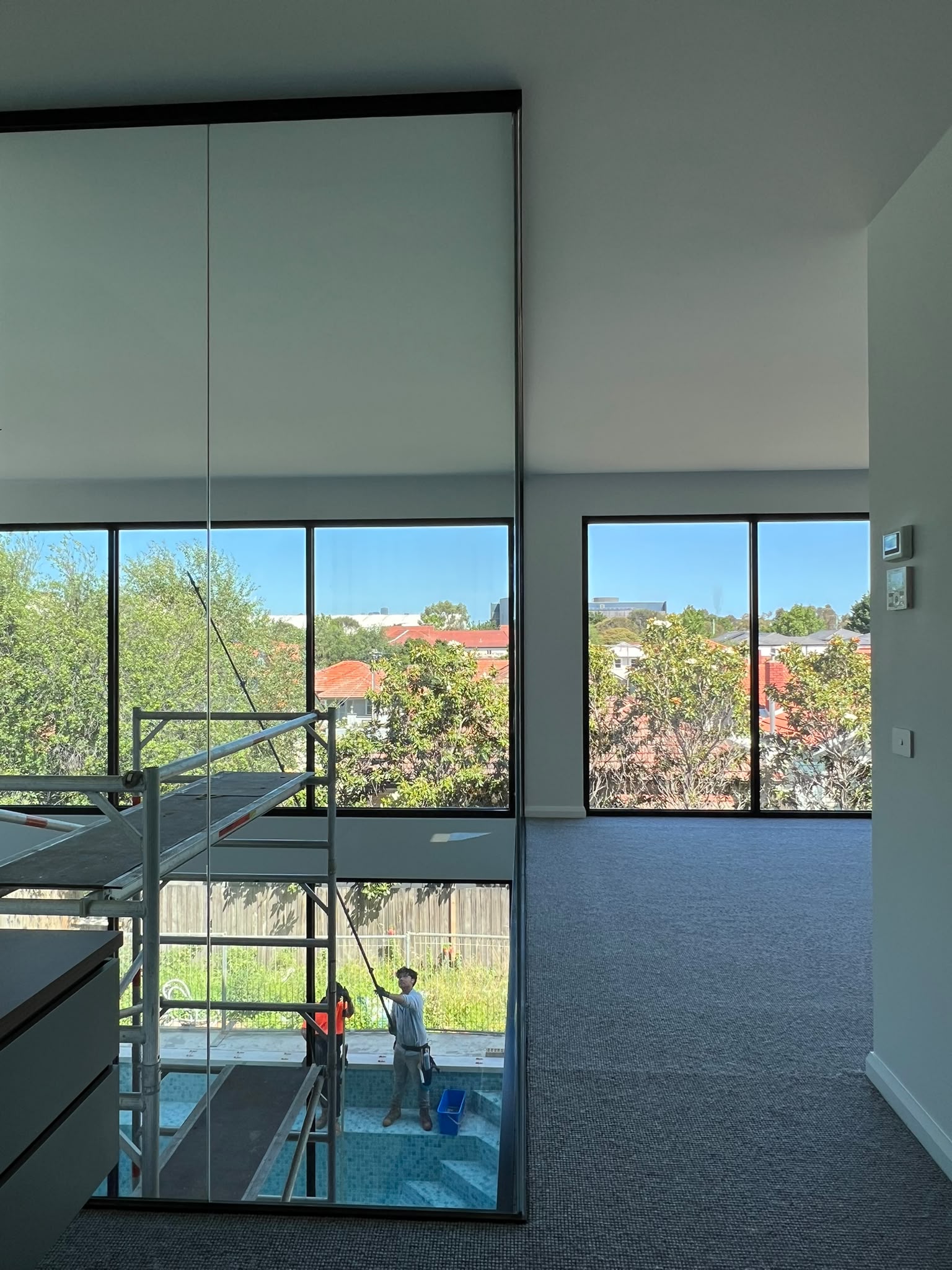 Large interior windows cleaned using high-reach equipment
