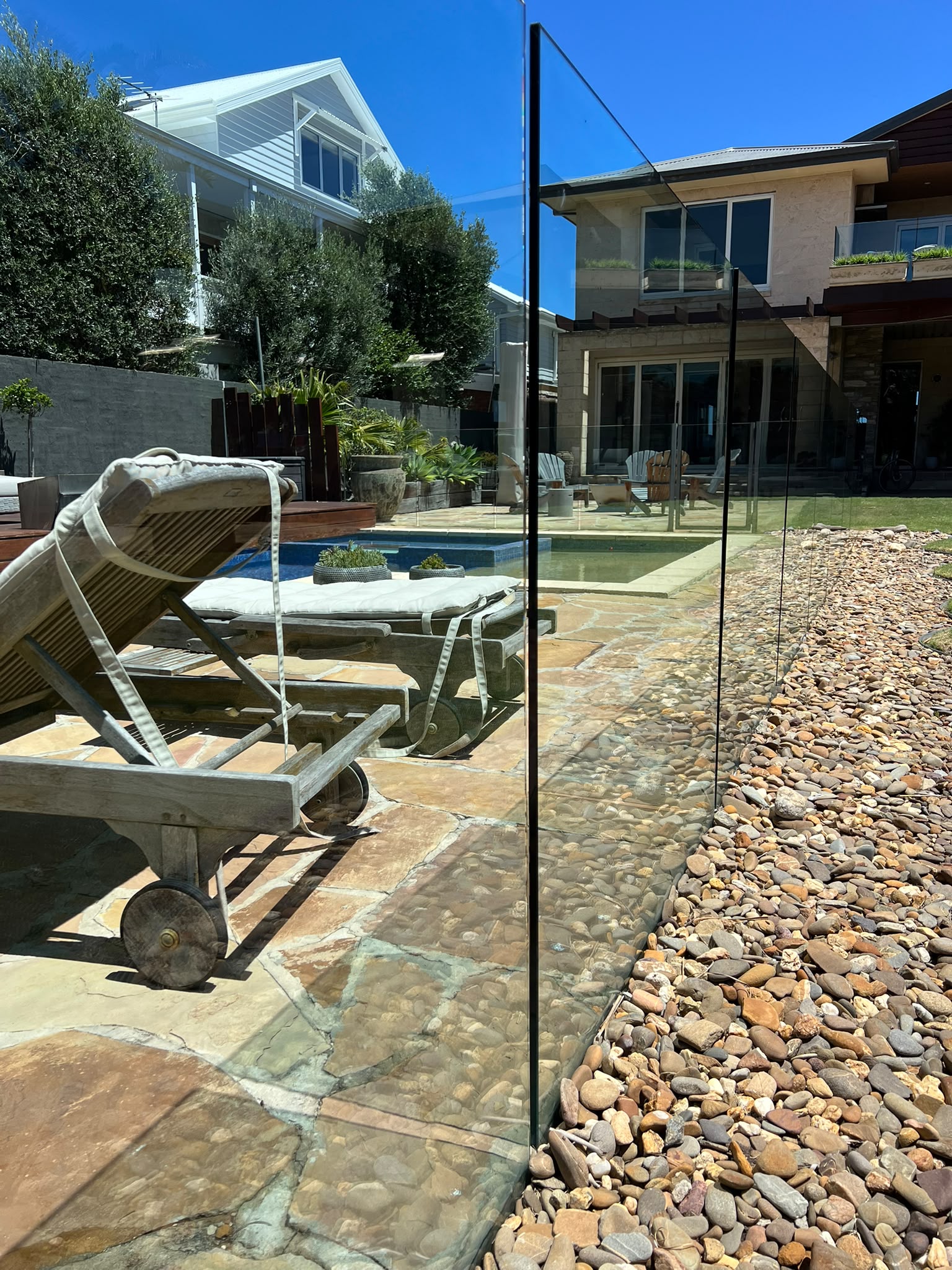 Close view through a clean frameless glass pool fence