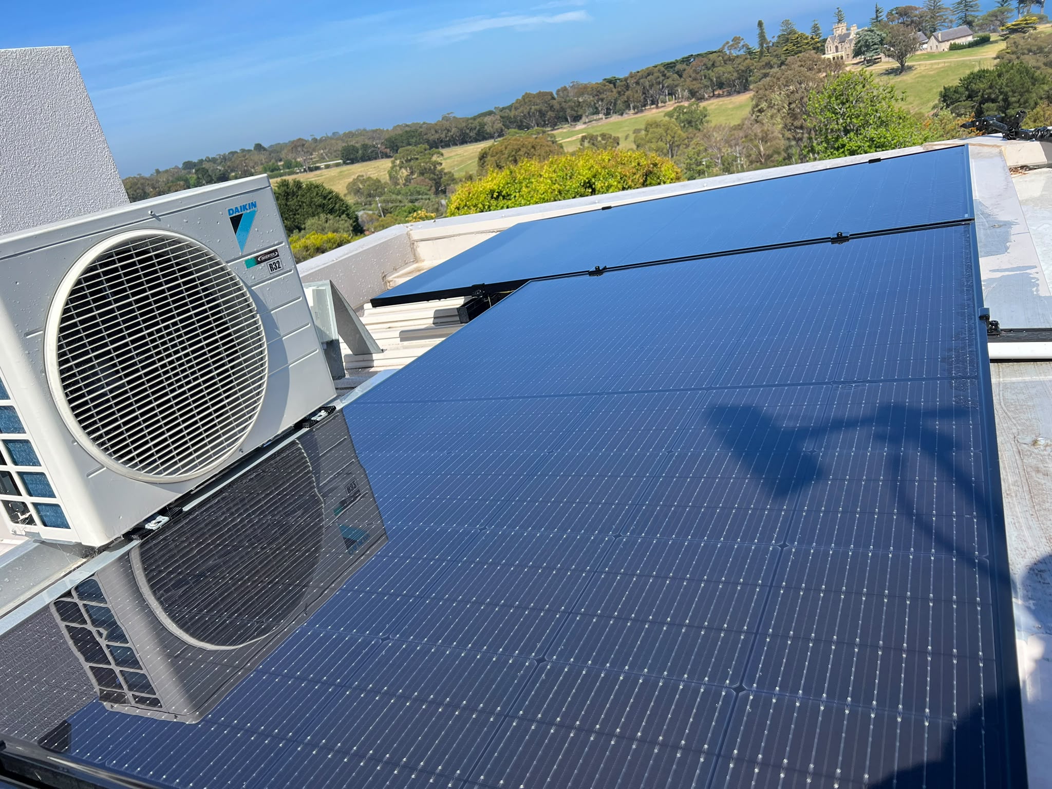 Clean rooftop solar panels reflecting the sky